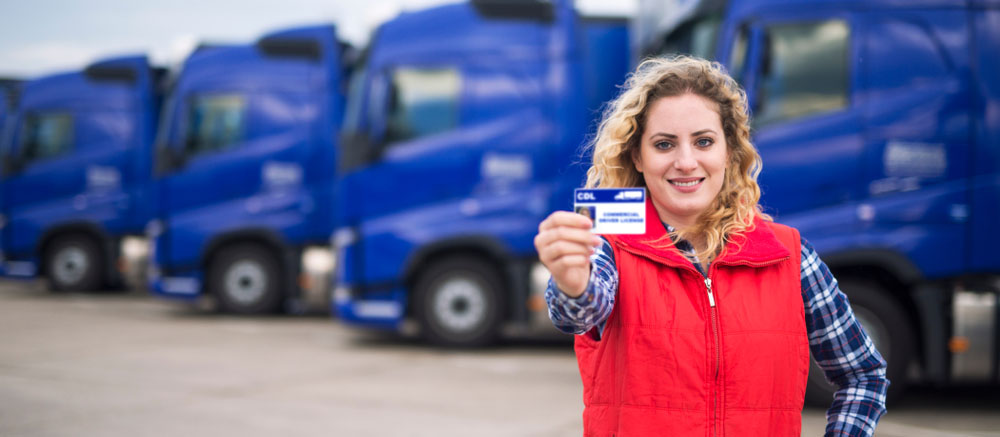 student truck driver proudly holding CDL